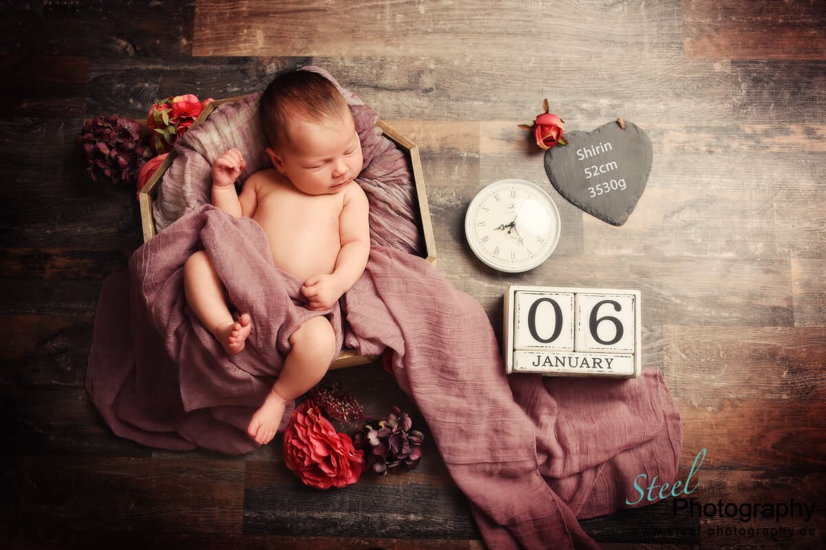 Baby liegend in Schale mit Geburtsdaten